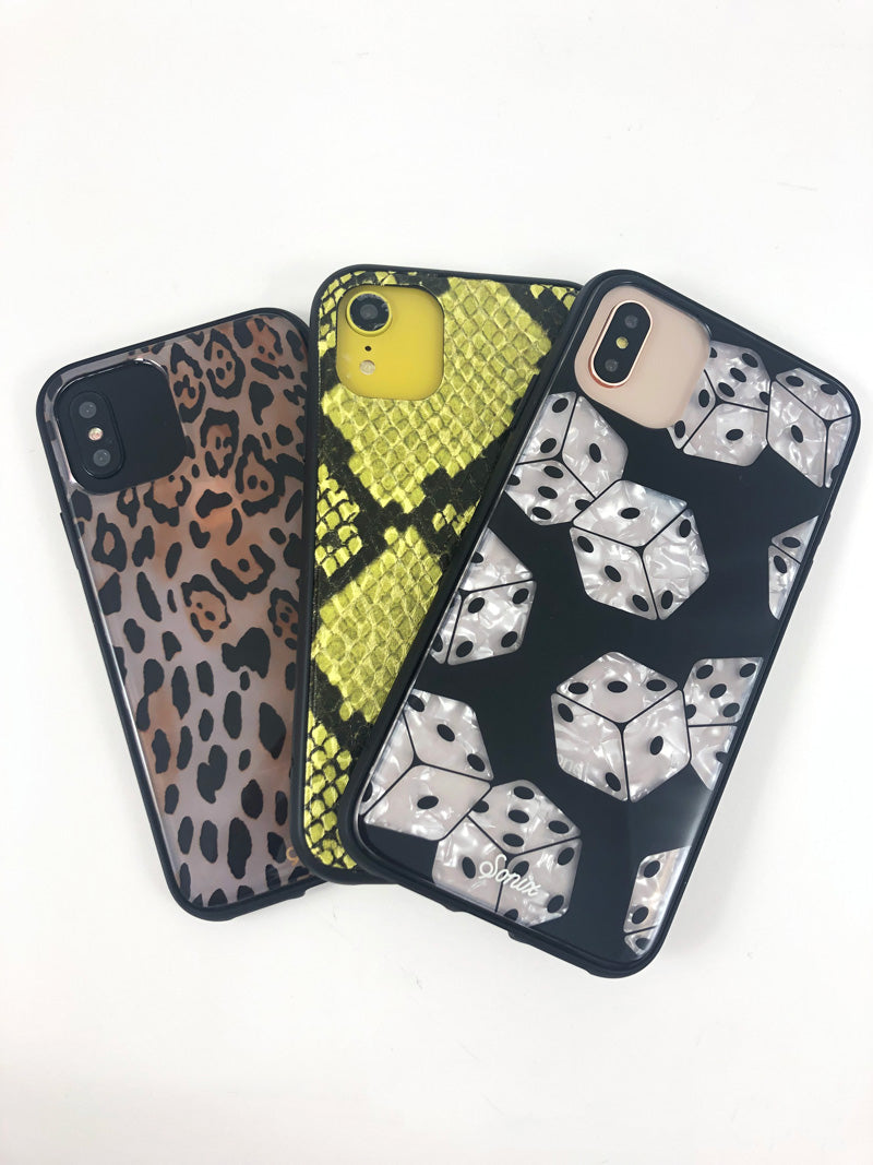 Top-down view of three Sonix iPhone cases showing different camera cutouts and patterned designs on a white background