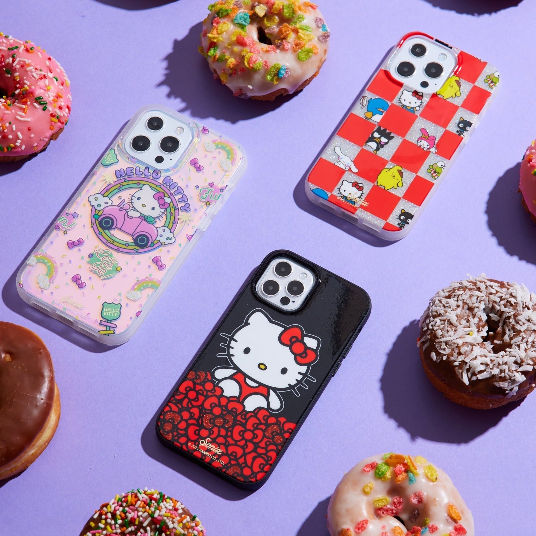 three hello kitty themed phone cases shown on a purple background