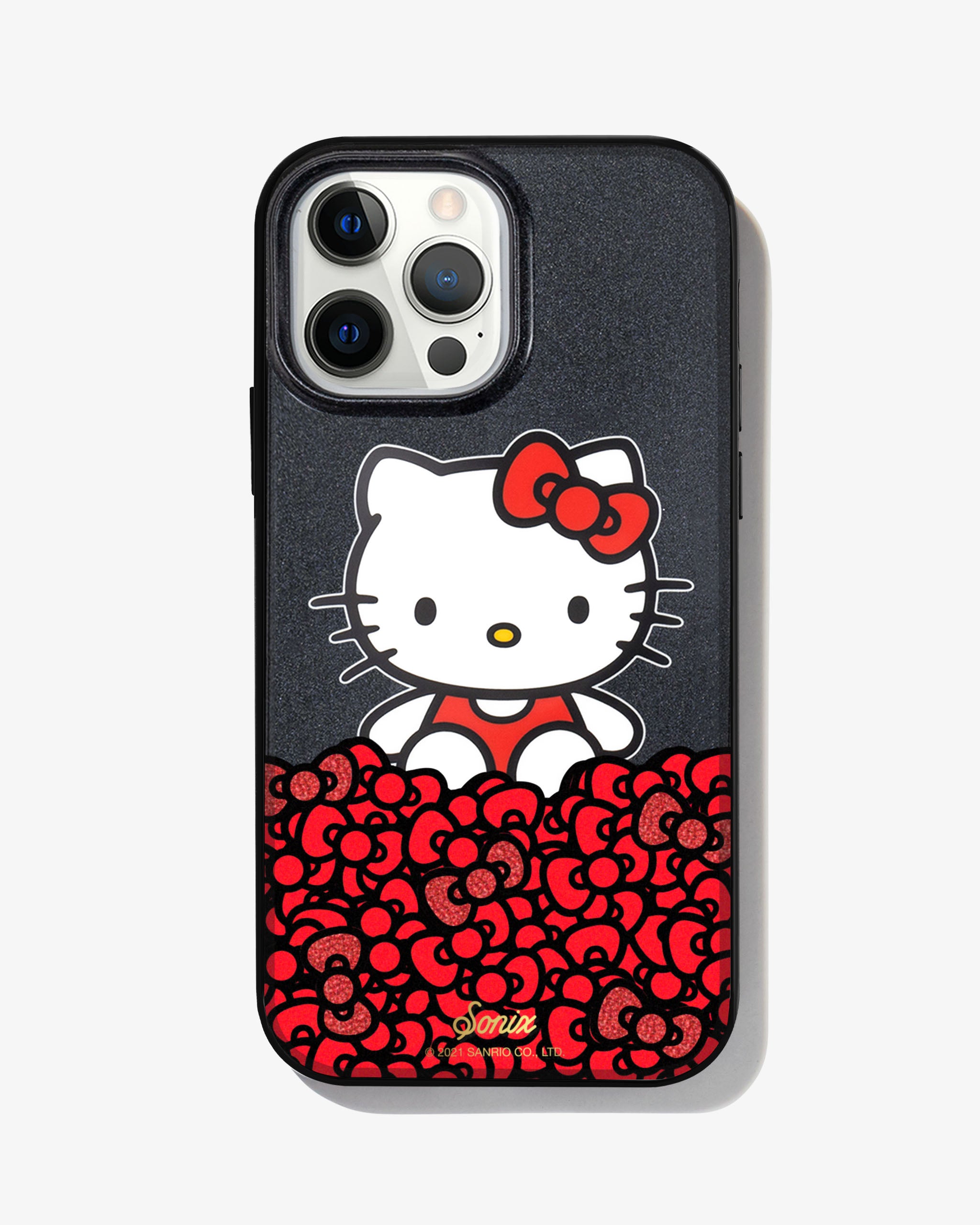 black glitter and Hello Kitty sitting on a bundle of her iconic red bows shown on a iphone 12 pro