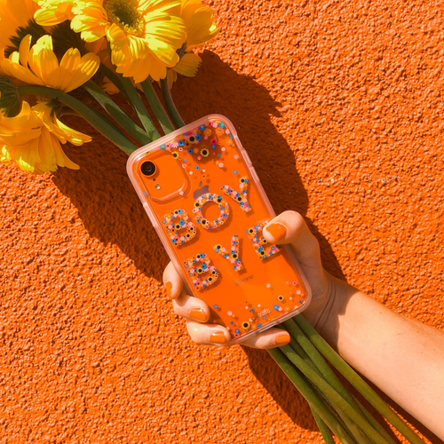 boy bye in floral letters shown on an orange iphone x 