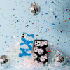 black case with white tort dice shown on an iphone with glitter confetti and disco balls in the background