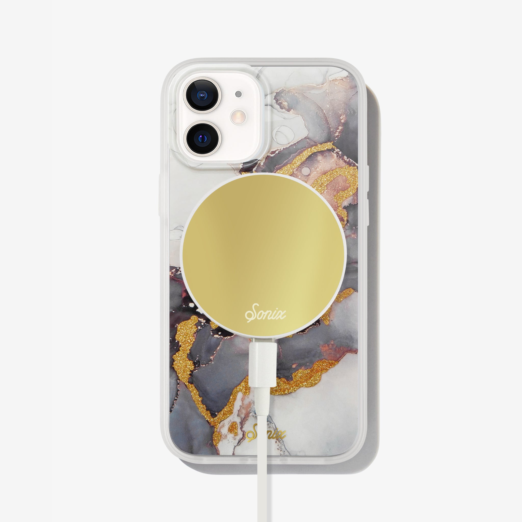 an intergalactic purple and dark colored design with gold glitter to bring out-of-this-world elements shown on an iphone 12  with a gold maglink charger on the back 