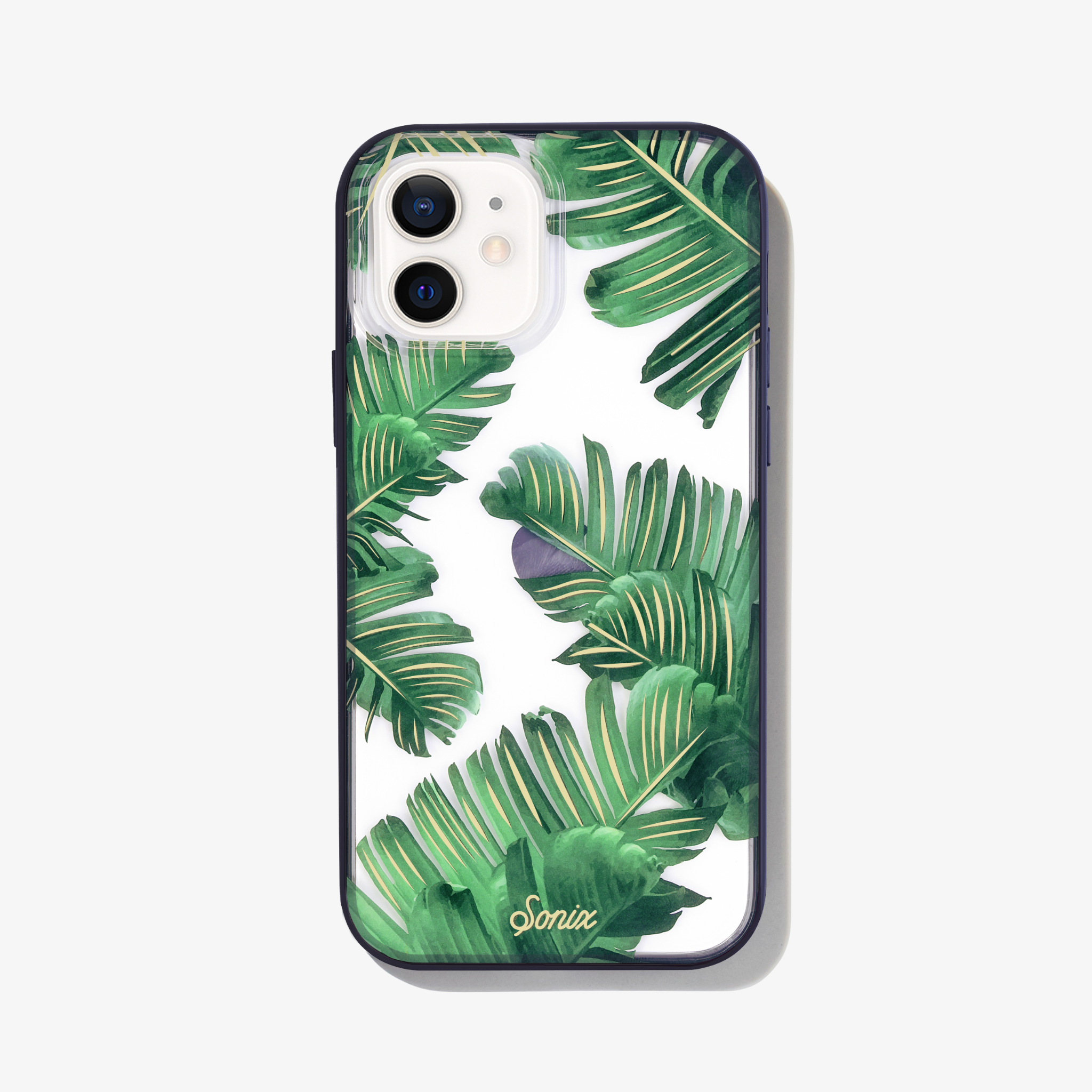 Bahama palm leaves iPhone 12 phone case on white phone.