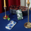 deep blue floral design with gold embroidered leaves shown on an iphone on a table