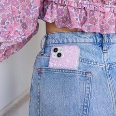 tort design with a shine that gleams in the light shown on an iphone in the back pocket of a girls jeans
